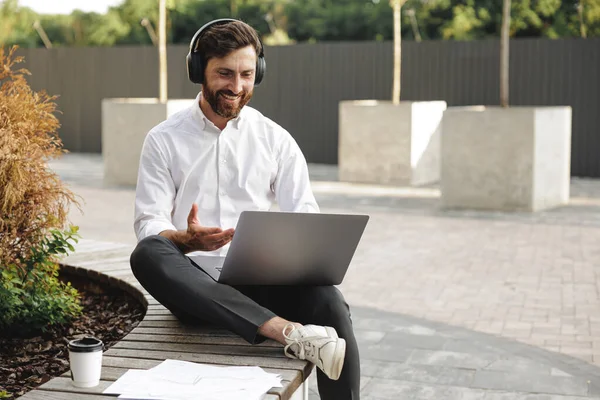 Caucasian Freelancer Wireless Headphones Working Portable Laptop While Sitting Urban Zdjęcie Stockowe