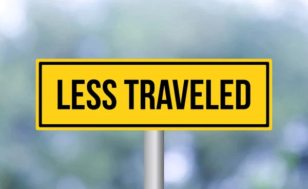 Less Traveled Road Sign Blur Background — Stock Photo, Image