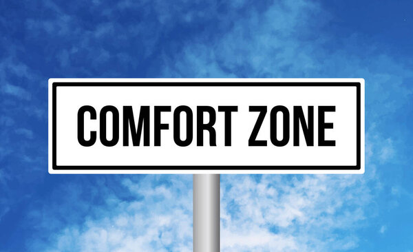 Comfort zone road sign on cloudy sky background