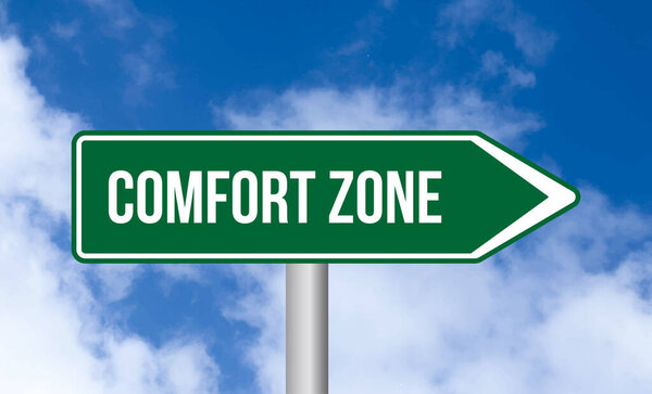 Comfort zone road sign on cloudy sky background