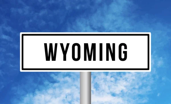 stock image Wyoming road sign on blue sky background