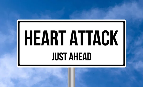 Stock image Heart Attack just ahead road sign on cloudy sky background