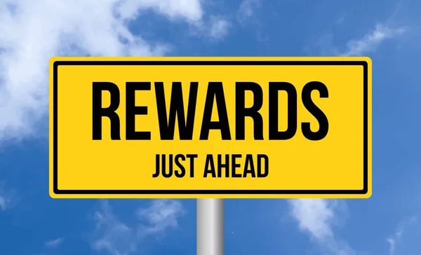 stock image Rewards just ahead road sign on cloudy sky background
