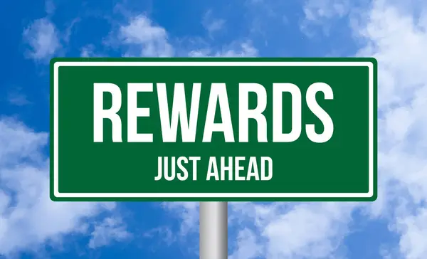 stock image Rewards just ahead road sign on cloudy sky background