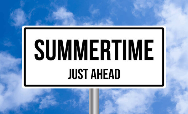 Summertime just ahead road sign on sky background