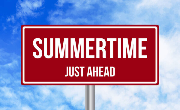 Summertime just ahead road sign on sky background