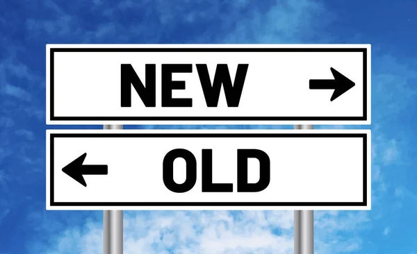 stock image New or old road sign on blue sky background