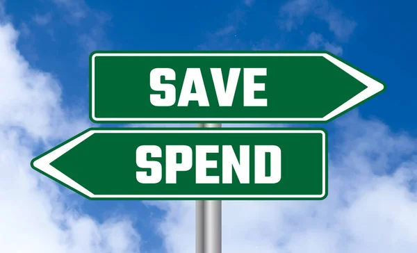 stock image Save or spend road sign on blue sky background