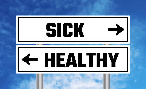 曇りの空の背景に病気や健康的な道路標識 — ストック写真