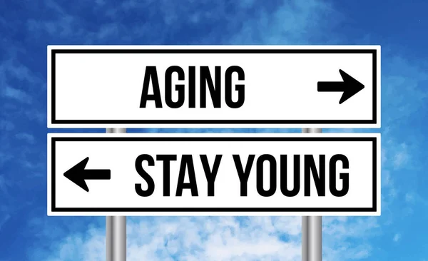 Aging Stay Young Road Sign Blue Sky Background — Stock Photo, Image