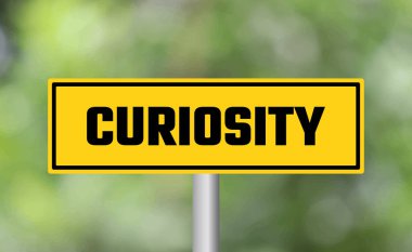 Bulanık arkaplanda merak yol işareti