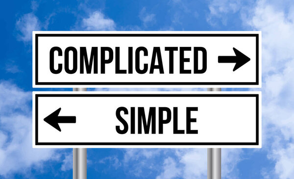 Complicated or simple road sign on blue sky background