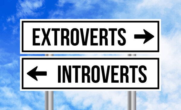 Extroverts or introverts road sign on cloudy sky background