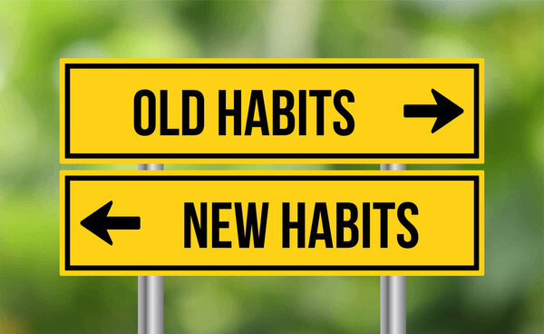 Old habits or new habits road sign on blur background