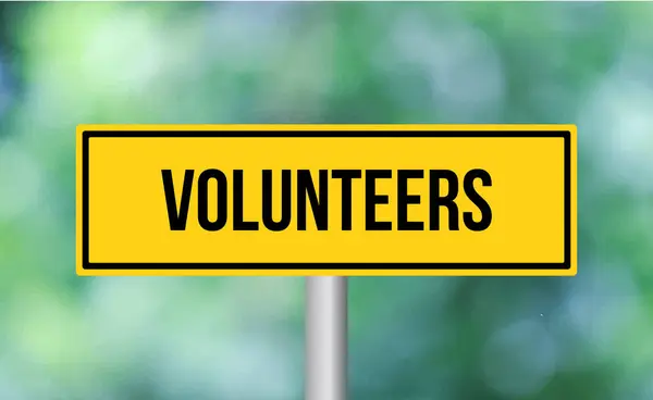 Volunteers Road Sign Blur Background — Stock Photo, Image
