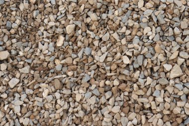 Çeşitli boyutlarda ve nötr tonlarda, doku veya yapı kavramları için uygun bir yığın kayanın tam bir çerçeve görünümünü gösterir.