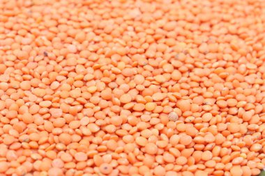 Yoğun kırmızı mercimek katmanlı bir makro çekim yakalar, zengin, dokulu bir zemin oluşturur mutfak veya besin bağlamları için uygun. Mercimek tek renk sergiler..