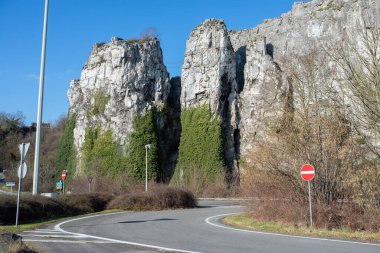 Old rocks in Namur with highway near it. Road signs