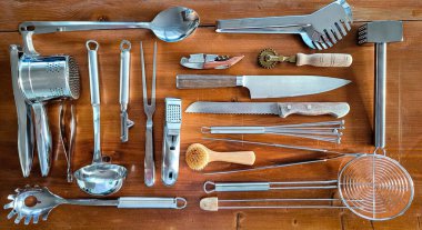 Top view of a set of kitchen equipment without plastic, which are located on a wooden surface. Kitchen concept clipart