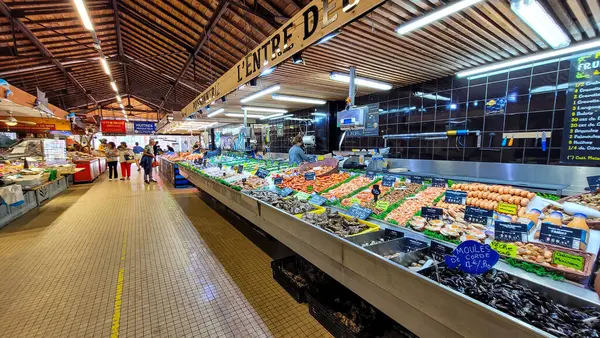 Fish market in Soulac-sur-Mer, popular summer resort in Nouvelle-Aquitaine, seaside resort on the Cote dArgent. Fishing dealers on the covered market. June 30, 2023. Soulac-sur-Mer, France.