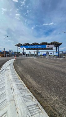 Asphalt road leading to a boarding on the ferry between Verdon-sur-Mer and Royan. Low angle. June 4, 2025. Verdon-sur-Mer, Gironde, Medoc, France.