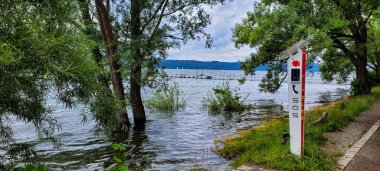 Emergency call column German Life Saving Association on the shore of the lake Constance, on the side of the pedestrian walkway. May 30, 2024. Uberlingen, Germany.