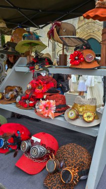 Caps and huts with flowers and aviator goggles in steampunk style. June 8, 2025. Soulac-sur-Mer, New Aquitaine, France