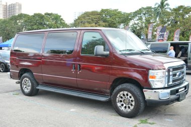 PASAY, PH - DEC 3 - Ford E150 van at bumper to bumper car show on December 3, 2022 in Pasay, Philippines. Bumper to bumper is a nationwide car show held in Philippines. clipart