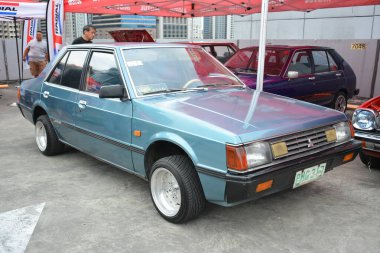 PASIG, PH - MAR 23 - Mitsubishi Lancer 23 Mart 2024 tarihinde Pasig, Filipinler 'de araba kulüpleri savaşında. Araba Kulübü Muharebesi, Filipinler 'de düzenlenen bir araba fuarıdır..