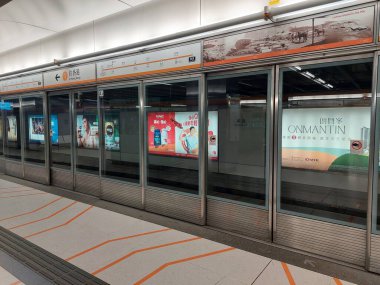 TUNG CHUNG, HK - Tung Chung Mtr platform on May 25, 2024 in Tung Chung, Hong Kong. Mtr or Mass transit railway is a major public transportation network serving Hong Kong. clipart