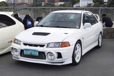 PASIG, PH - NOV 23 - Mitsubishi lancer evolution at DBTK Auto Salon on November 23, 2024 in Pasig, Philippines. Dont Blame the Kids or DBTK Auto Salon is a car show event held in Philippines. clipart