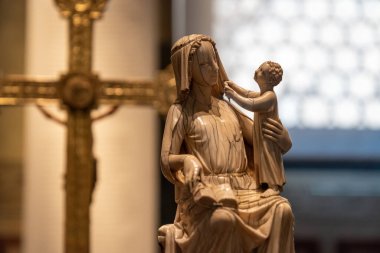 Close-up on miniature of Virgin Mary holding Jesus as a kid sculpted in marble