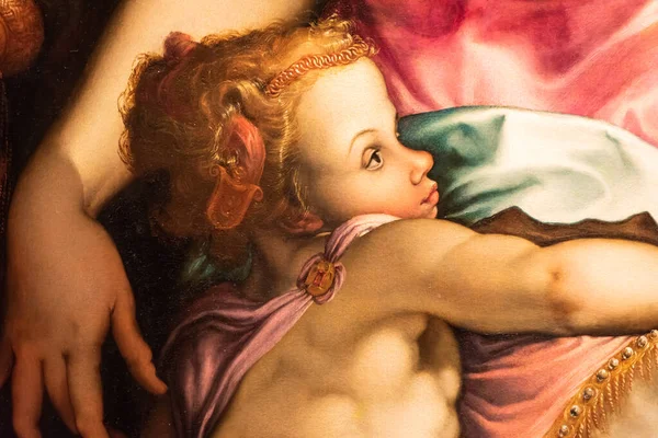 Close-up on renaissance painting showing the profile of a blond and muscular boy