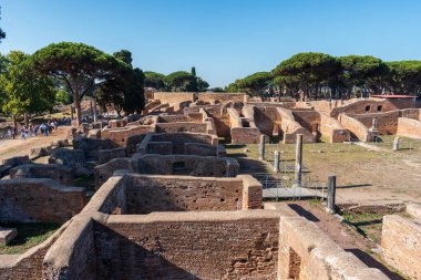 Antik Ostia 'daki arkeoloji parkında turistler tarafından ziyaret edilen antik Roma binalarının yapısı