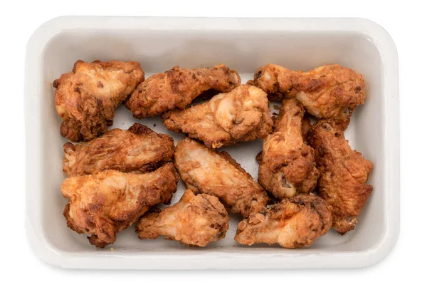 Pre-cooked fried chicken wings in plastic food tray for supermarket sale , isolated on white with clipping path