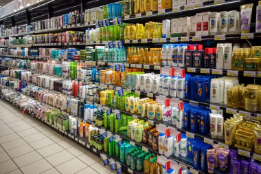Italy - February 5, 2023: Various types and brands of cosmetics and hair care products on sale in an Italian supermarket