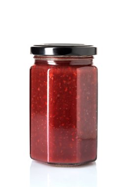 Raspberry jam in glass jar with black cap isolated on white with clipping path