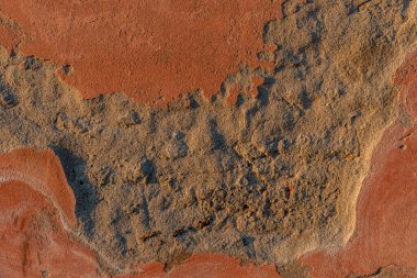 Texture of peeling pink plaster with concrete view, crumbled plastered wall, copy space
