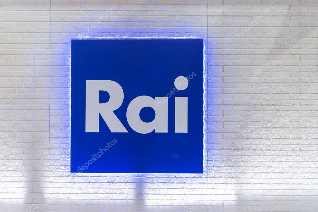 Turin, Italy - May 22, 2023: Logo of RAI Radio Televisione Italiana on sign on white brick wall. RAI is broadcasting company of Italy