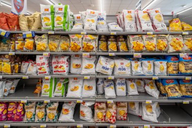 İtalya - 17 Temmuz 2023: Bir İtalyan süpermarketinde satışa sunulan çeşitli marka ve tiplerdeki patates cipsleri 