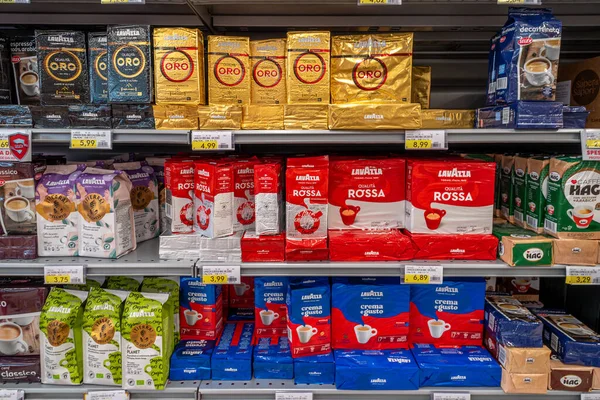 stock image Italy - August 14, 2023: Lavazza coffee in packs of various types and colors displayed on shelf for sale in Italian supermarke