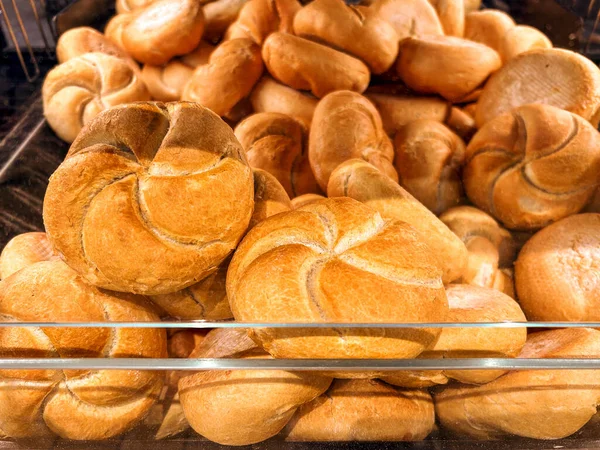 Loaves of Italian bread called rosetta in window self-service dispenser for sale in Italian supermarket