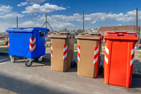Bins for separate waste collection of various colors at Italian roadside