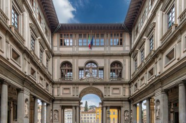 Uffizi Gallery in Florence view of the access courtyard with arcades with columns and arches and statues clipart