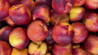 Süpermarkette sergilenen şeftali rengi şeftaliler, şeftali şeftalilerinin üstündeki kaydırıcı izleme görüntüsü