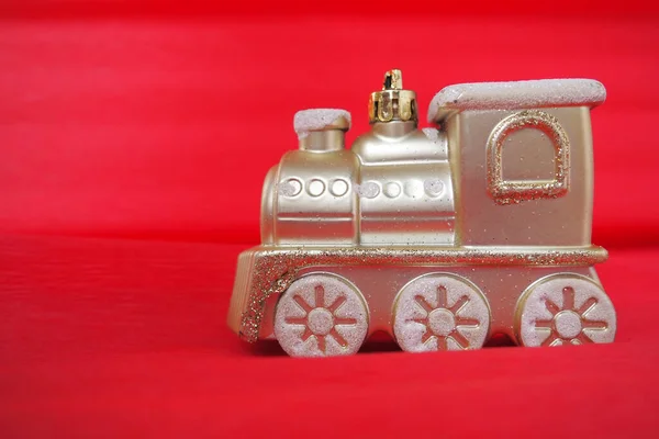 빨간색 분홍색의 배경에 황금색 장난감 열차가 있습니다 새해나 크리스마스 기차에는 — 스톡 사진