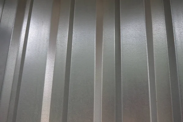 aluminum chrome metal profiled sheet with vertical stripes. metallic gray.