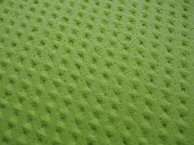 Sponge fibers sponge texture pattern surface close-up green yellow background.