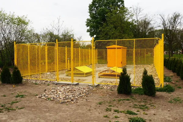 ground with tanks for liquefied gas. Modern gas installation with protective fencing. Yellow fence. Supply of gas to population. Connection of houses to energy. Gas and energy prices. Planted thuja.
