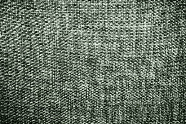 green background fabric texture. A piece of woolen cloth is neatly laid out on the surface. Weave and textile texture. Dress fabric or for kitchen needs, tablecloth or curtains, close-up. Dash.